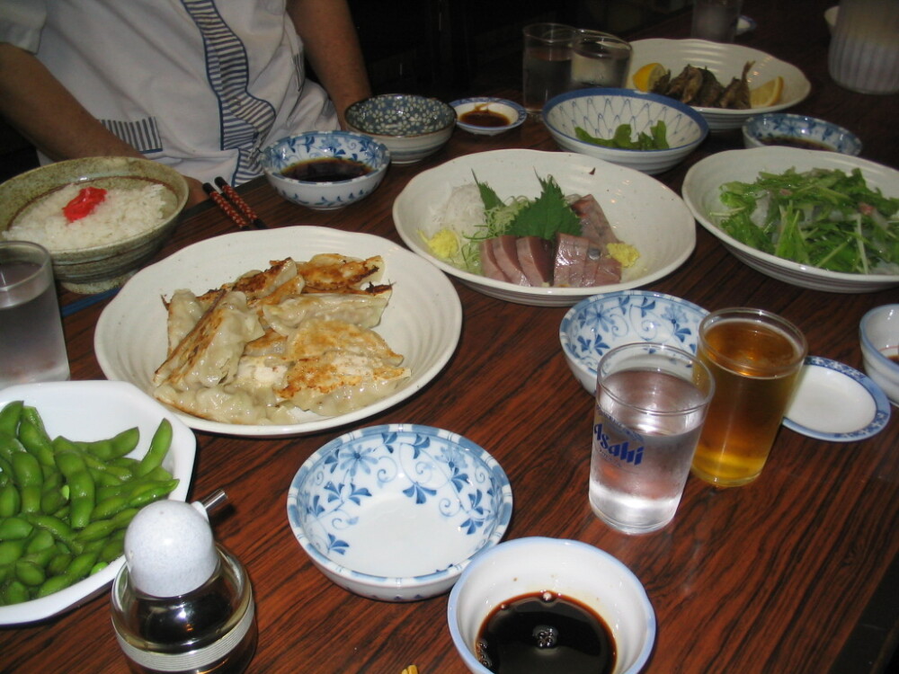 Tokyo, Japan :: More food from my friend's parent's place. Gyoza- my absolute favorite dish (next to tonkatsu), tuna sashimi, edamame, seaweed salad (I believe), and it looks like fried fish at the end of the table and of course rice on the side. I am so grateful to these people for the food they gave me!