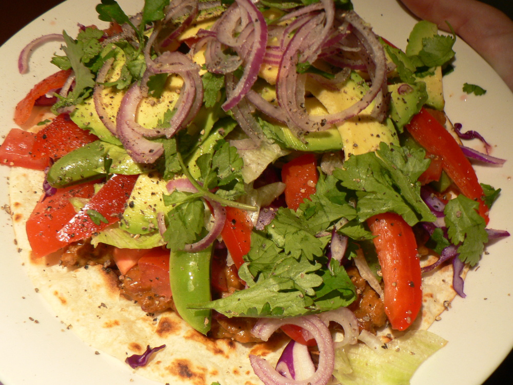 Brisbane, Australia :: I've always called this a "stack" but I think it's actually supposed to be a called a TOSTADA! 

I believe I originally found this recipe in a Weight Watchers cookbook and its been a keeper ever since!

I make a spicy Mexican-style mixture to put on a toasted tortilla -- usually kidney bean but this time it was beef and bean.  The original recipe called for refried beans which are MAGNIFICENT as well........ just use your imaginations as to what toppings! 

I then pile it high with avocado, capsicum, lettuce, red onion, tomatoes, fresh coriander -------> (ESSENTIAL)and usually a dollop of sour cream and maybe guacamole ;-) This time I also added shredded red cabbage and sugar snap peas coz that's what I had in the fridge and now I don't know how I ever did without them! Just use any salady-type veggies that you have in the fridge that you enjoy! 

This is a HUGE HIT with my man as it's basically one HUGE salad!!

This was one of the meals that I ate very regularly on the points programme coz it's SO filling and it feels like i'm eating a REAL MEAL!  On WW, most vegetables are "points" free so with a recipe like this you can GO WILD!!!

OH and PS, this is very quick to make, basically as long as it takes to open a can of refried beans and chop up some salad.... very good for a healthy yet delicious weeknight dinner!