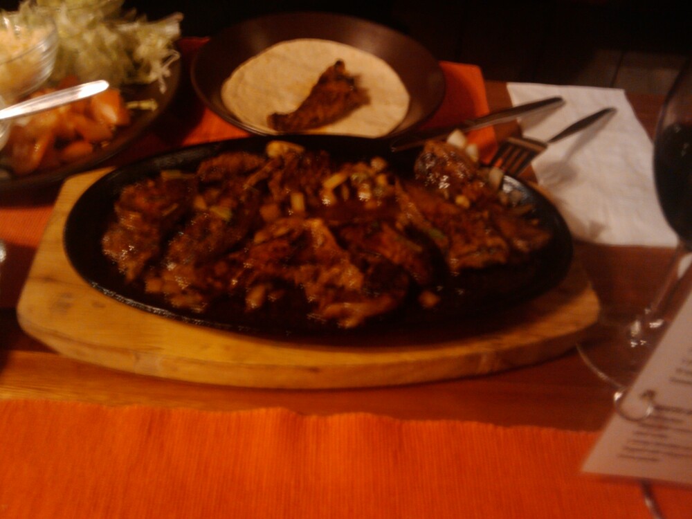 Brisbane, Australia :: This was my partner's meal and it was definitely the star of the evening!!!!  Sorry about the poor picture quality, he didn't want to waste a second!!!

Here is the description from the restaurants website of the meal- 


Fajita's (our signature dish)	
Your choice of tender chicken breast, rib fillet, or juicy fresh prawns seasoned in our famous mesquite flavoured marinade. Served on a sizzling platter with salad, sour cream, guacamole and a warm flour or white corn tortilla stack for a true feast, created at your table! Delicious! 