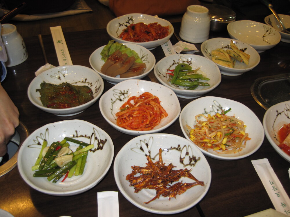 Seoul, South Korea :: Sides that came with soup. Bean sprouts, acorn extraction, dried fish, hot peppers, kimchi, other weird stuff!