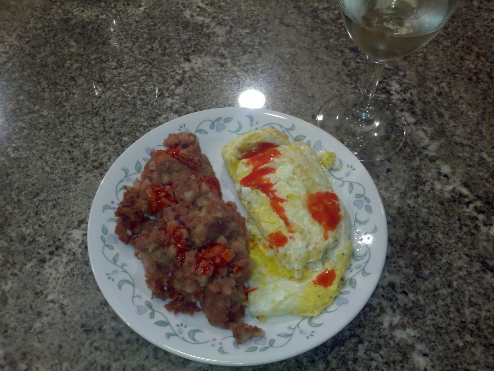 Milford NH :: beef hash with eggs over hard and Goya hot sauce with a glass of white wine