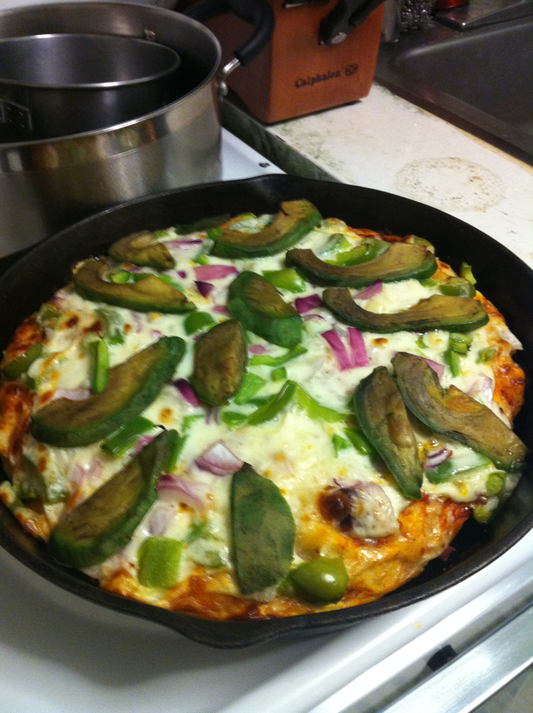 Brookline :: Homemade pizza in cast iron skillet loaded with red onions, green peppers, avocado, and whole milk mozzarella.