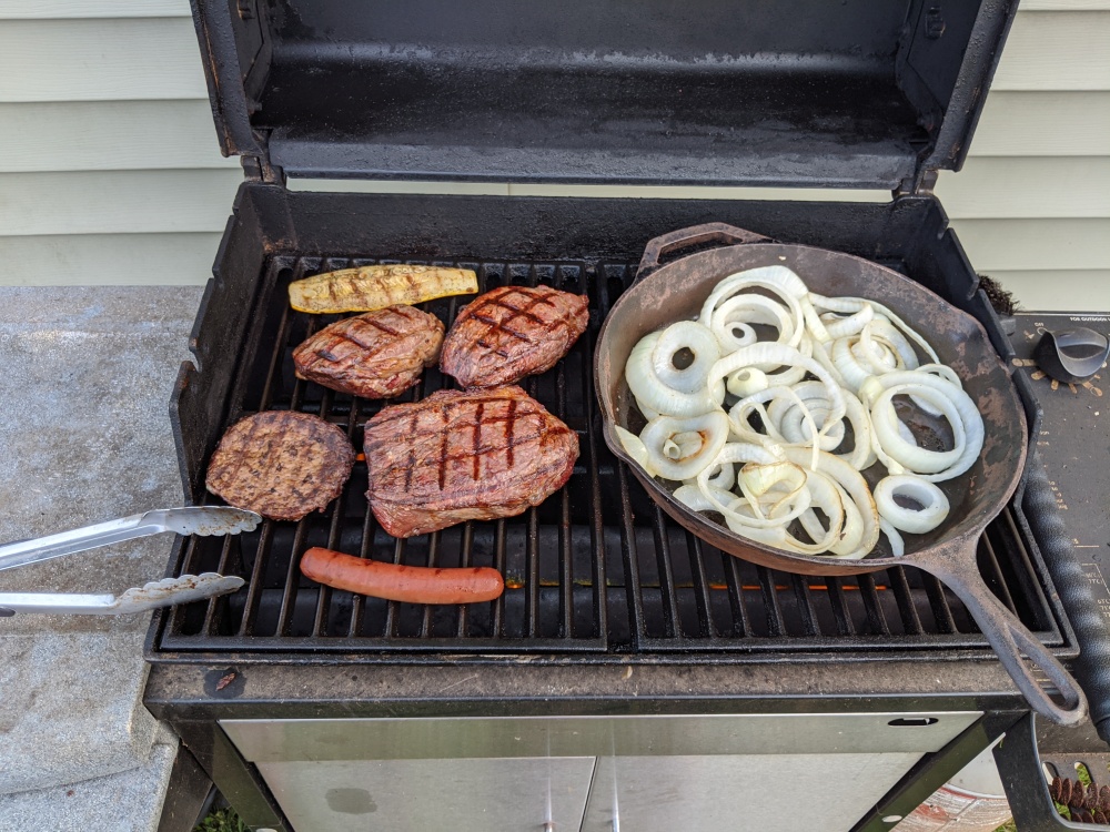My backyard :: Can't you see? Just your weekly dose of steak and onions on a hot Weber Grill