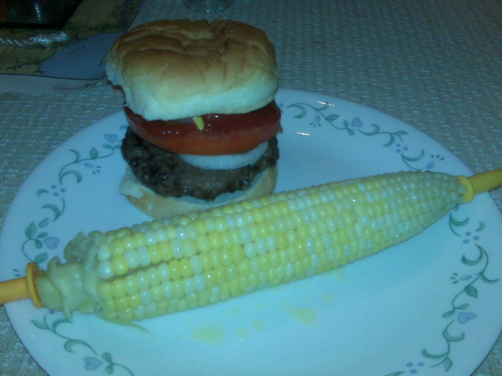 Milford NH :: Burger with dill relish, ketchup, mustard, and a home-grown tomato slice.  Corn on the cob steamed over the stove.  Grilled corn is much better.