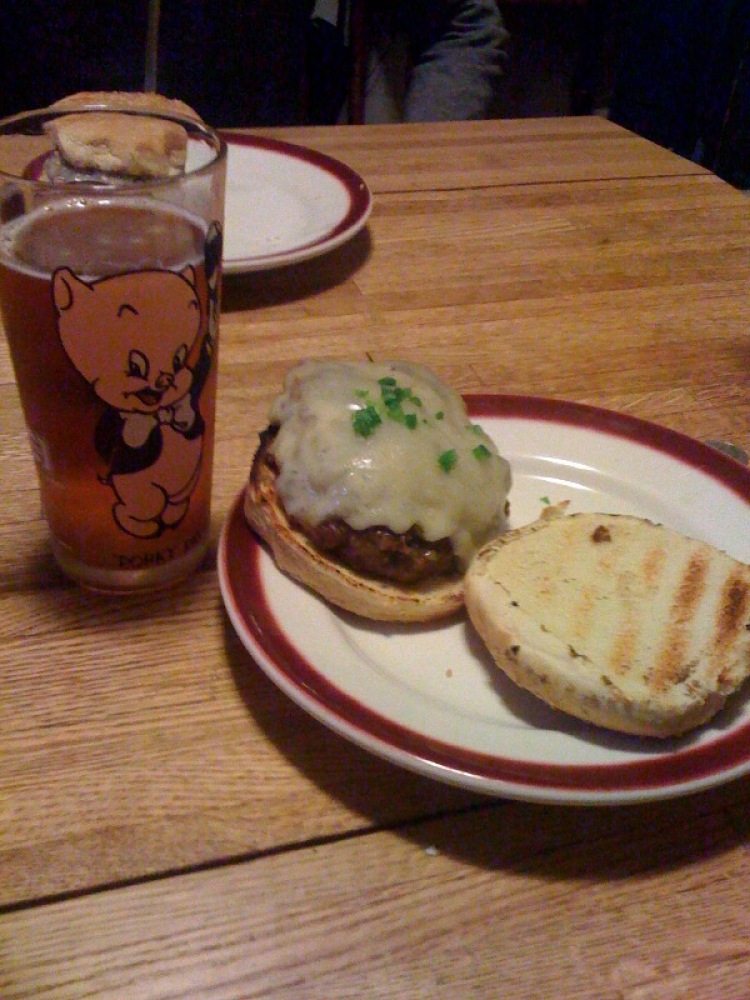 My House Cambridge, MA :: this is a classic meat-loaf burger that my buddie and I make.... this time we topped the meat patty with caramelized onions garlic and hot peppers... put 2 slices of melted swiss on top and it was yummie time!  also a fresh harpoon IPA in a Porky-Pig glass!  