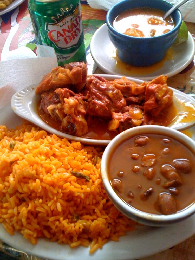 Izzys's Cambridge, MA :: stewed goat over yellow rice!  one of the best meals!!!  the goat meat looked red.. but that was what made it look red... goat is yummie!  beans too!!