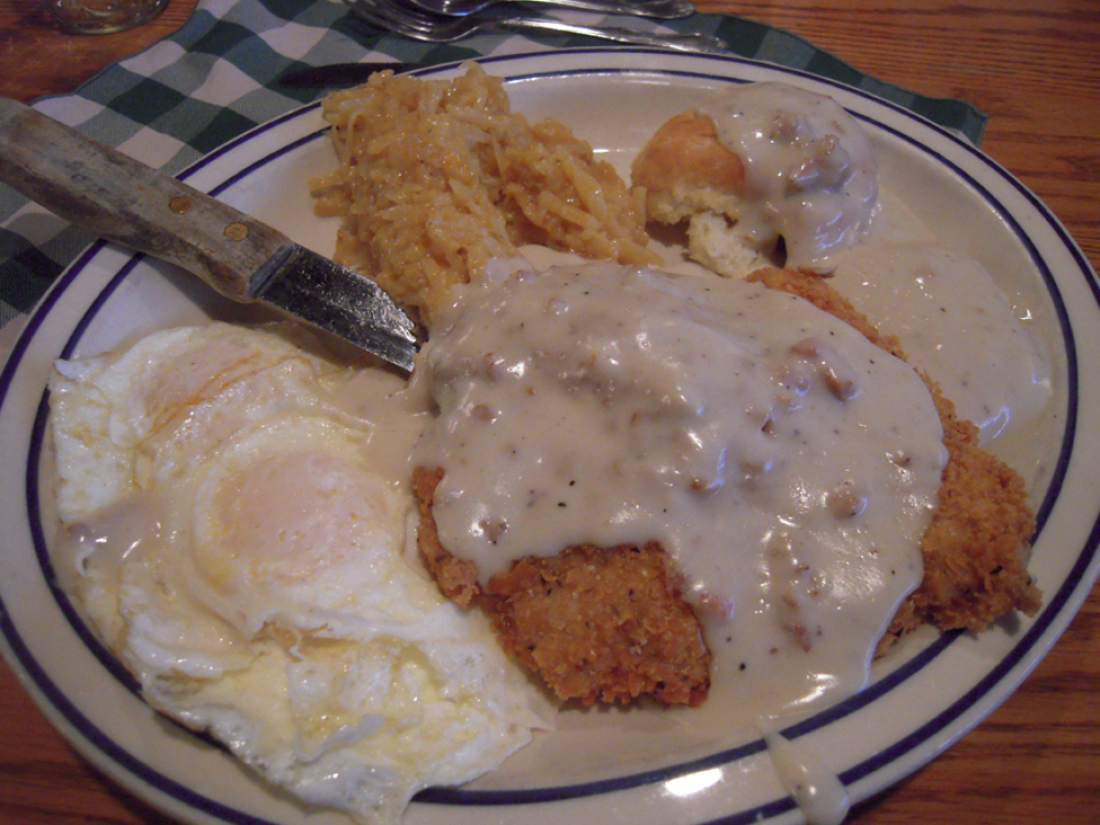 Machine Shed Rockford, IL :: This was my breakfast at The Machine Shed! I had Chicken Fried Pork, 3 over-easy eggs(if you say "I love eggs" they give you an extra no cost egg! I did and that is how I got 3 eggs!), Bisects and Gravy, and the Casserole... 