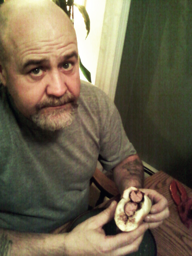Milford, NH :: My father-in-law Gary eating a double-decker Icelandic lambdog with all the fixings. Despite his the look on his face, he is actually overjoyed to be eating this.