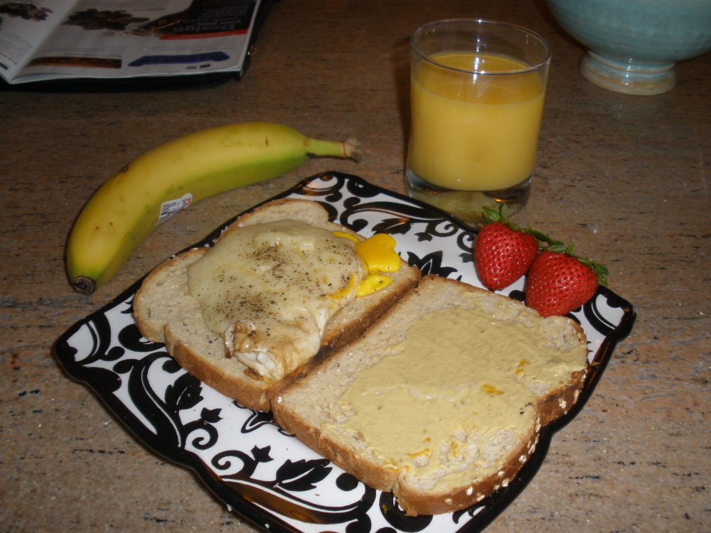 Home :: egg and extra sharp cheddar cheese sandwich on oatnut bread with cracked pepper and a smeer of grey poupon. strawberries and banana and oj for three different fruits!